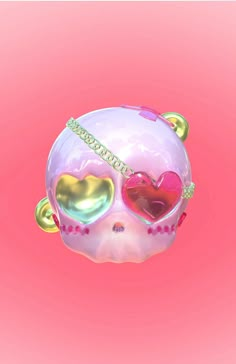 a pink skull with two hearts on it's face and gold chains around its neck