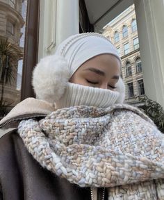 a woman wearing a white hat and scarf