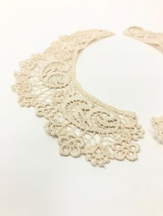 "Beautiful vintage beige ivory floral lace collar, comes in two separate pieces. Perfect for sewing together and adding a button on the back or for any other sewing projects. Crochet style lace. Collar is not attached, will need to be sewn together. Measurements Length: approx 8\" Width: 2.25\" All of our items are VINTAGE NOS (new old stock/ deadstock), they have been stored in their original packaging in a climate controlled environment. Some items will come with the original tags. **Please me Beige Bohemian Crochet Lace, Bohemian Beige Crochet Lace, Bohemian Cream Crochet Lace, Cream Bohemian Lace With Lace Trim, Bohemian Cream Lace With Lace Trim, Fitted Beige Crochet Lace, Crochet Style, Lace Collar, Wedding Supplies