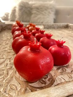 red tomatoes are lined up on a tray