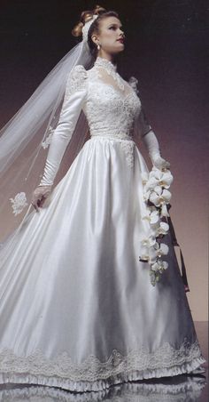 a woman in a white wedding dress and veil