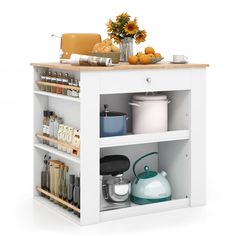 a white kitchen island with pots, pans and other cooking utensils on it