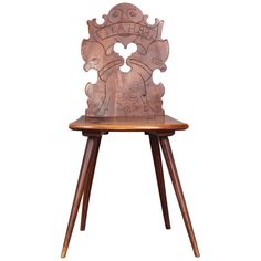 a wooden chair with carvings on the back