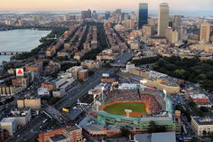 an aerial view of a baseball stadium in the middle of a city with lots of tall buildings