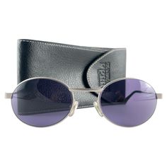 New Vintage Gianfranco Ferre Sunglasses Oval Silver brushed metallic Frame Holding A Pair Of Spotless Purple Lenses New, Never Worn Or Displayed This Item May Show Minor Sign Of Wear Due To Storage Made In Italy Front 14.5 Cms Lens Height 4 Cms Lens Width 5.7 Cms Temples 13.5 Cms Sunglasses Oval, Purple Lenses, Metallic Frame, Gianfranco Ferre, Brushed Metal, New Vintage, Sunglasses Accessories, Metal Frame, Lenses