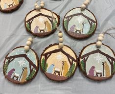 wooden ornaments with nativity scenes painted on them