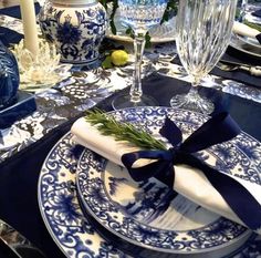 a blue and white table setting with place settings