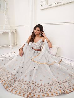 Introducing our exquisite "beautiful white sequins net festival wear lehenga choli with dupatta", a stunning ensemble that will make you stand out at any special occasion. This beautiful white lehenga features intricate embroidered work, thread work, and sequin work on butterfly net material, giving it a graceful and elegant look. The accompanying choli and dupatta are crafted from similar color butterfly net material with matching embroidered work and sequin details.
The semi-stitched lehenga c White Dress For Diwali Celebration, White Party Wear Anarkali Set With Sheer Dupatta, White Anarkali Set With Sheer Dupatta For Party Wear, White Anarkali Set With Mirror Work For Party, White Floor-length Anarkali Set For Party Wear, White Choli With Sheer Dupatta For Party, White Anarkali Sharara For Party, White Fitted Anarkali Set For Party, Festive White Choli With Sheer Dupatta