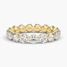 a yellow gold ring with five round diamonds