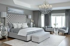 a bedroom with gray walls and white furniture