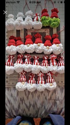 there are many red and white pom poms on the shelf next to each other