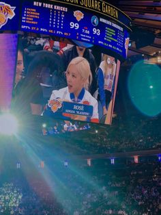 a person on a big screen at a basketball game