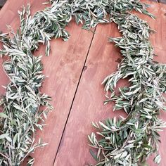 an olive wreath sitting on top of a wooden table