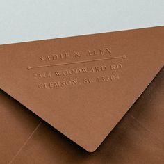 a close up of an envelope with a brown paper on it and the address stamp