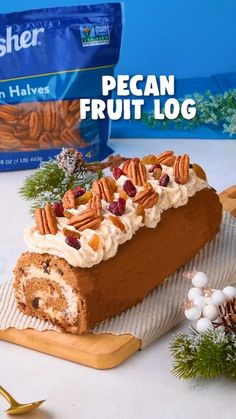 a loaf of pecan fruit log on a cutting board next to nuts and pine cones