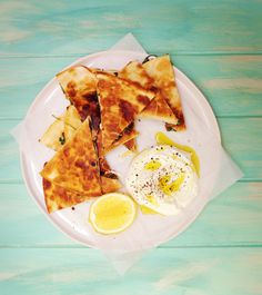 a white plate topped with quesadillas and an egg