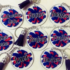 six personalized keychains with tassels and name tags in red, white, and blue