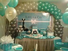 a table set up for a baby's first birthday party with balloons and decorations