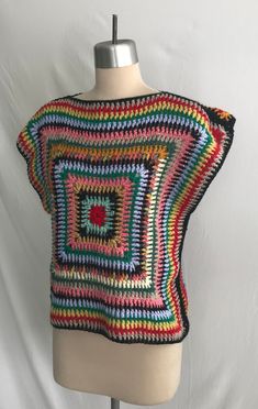 a crocheted top on a mannequin head with a white wall in the background