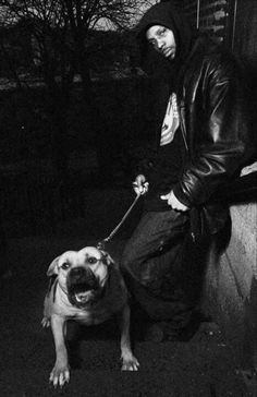 a black and white photo of a man with a dog