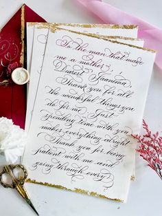 the wedding stationery is laid out on top of the table with scissors and flowers