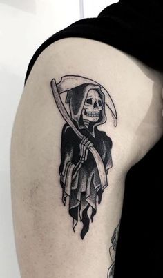 a person with a tattoo on their arm holding a knife and wearing a skull mask