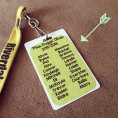 a keychain with a name tag attached to it and an arrow next to it