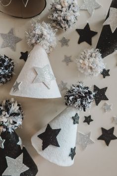 black and white party hats with silver stars on the top, surrounded by confetti cones