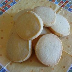 some cookies are sitting on top of each other in the middle of a tablecloth