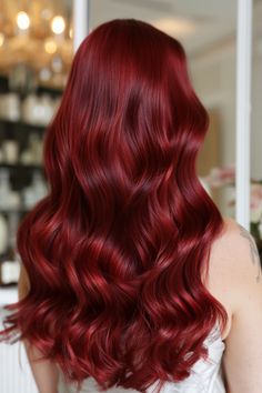 Indulge your bold side with deep cherry red hair. This fiery hue exudes confidence and mystique, making it a striking choice for those seeking a daring and captivating look. Embrace the unique vibrancy that comes with this rich color - it's a timeless favorite that never fails to turn heads. Step into your power and let your inner fire shine through with this alluring shade that commands attention wherever you go. Poison Ivy Hair Color, Poison Ivy Red Hair, Expensive Red Hair, Intense Cherry Red Hair, Intense Red Hair Color, Deep Vibrant Red Hair, Vibrant Natural Red Hair, Dark Cherry Hair, Deep Red Hair Color