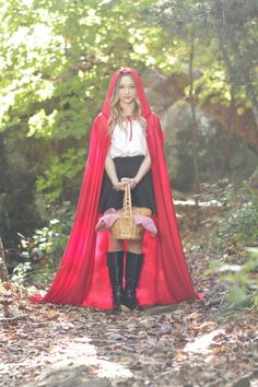 a woman dressed as a red riding hood and holding a basket