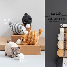 crochet kit with cat and kitten figurines sitting on top of each other