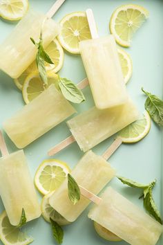 popsicles with lemon slices and mint leaves on a blue tray, ready to be eaten