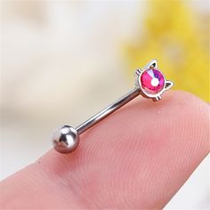 a tiny pink nose ring with a cat on it