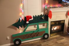 a green car with a christmas tree on top and stockings hanging from the fireplace mantel