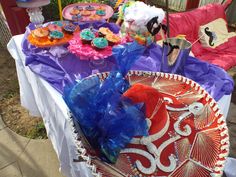 a table topped with lots of colorful cakes and cupcakes