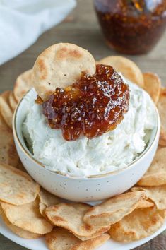 a white bowl filled with dip and crackers