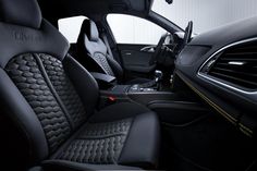 the interior of a car with black leather and yellow stitching