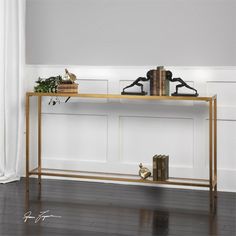 a console table with books and plants on it