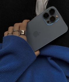 a person holding an iphone 11 in their hand with the camera on it's back