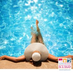 a woman in a white hat is floating in a swimming pool with clear blue water