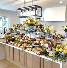 a table filled with lots of food sitting on top of a kitchen counter