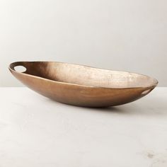 a large metal bowl sitting on top of a table