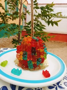 a plate with gummy bears on it and a tree in the back ground behind it