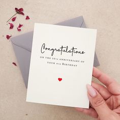 someone holding up a card with congratulations written on it