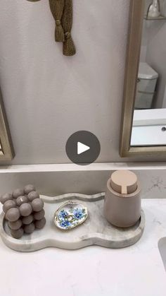 a bathroom sink with soap dispenser, mirror and other items on it