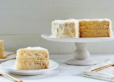 three pieces of cake on white plates with gold forks