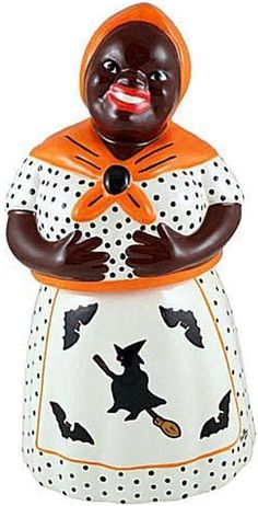 a ceramic figurine with an orange and black hat