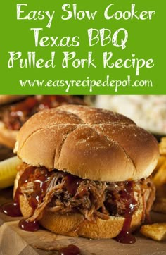 a pulled pork sandwich sitting on top of a wooden cutting board next to french fries