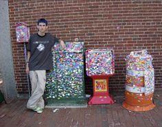 a young man standing next to three colorful machines